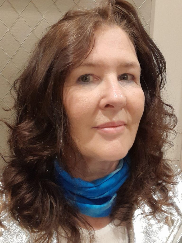 photo of Bernie she is a white woman with long brown wavy hair and